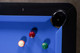 Corner pocket detail of the Doc & Holliday Poshy Reverse Rainbow pool table with leather pocket, black gloss rails, and Euro Blue felt. Corner pocket detail of the Doc & Holliday Poshy Reverse Rainbow pool table with leather pocket, black gloss rails, and Euro Blue felt.